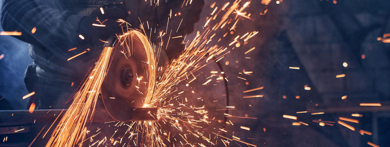 man-special-suit-polishing-metal-with-angle-grinder